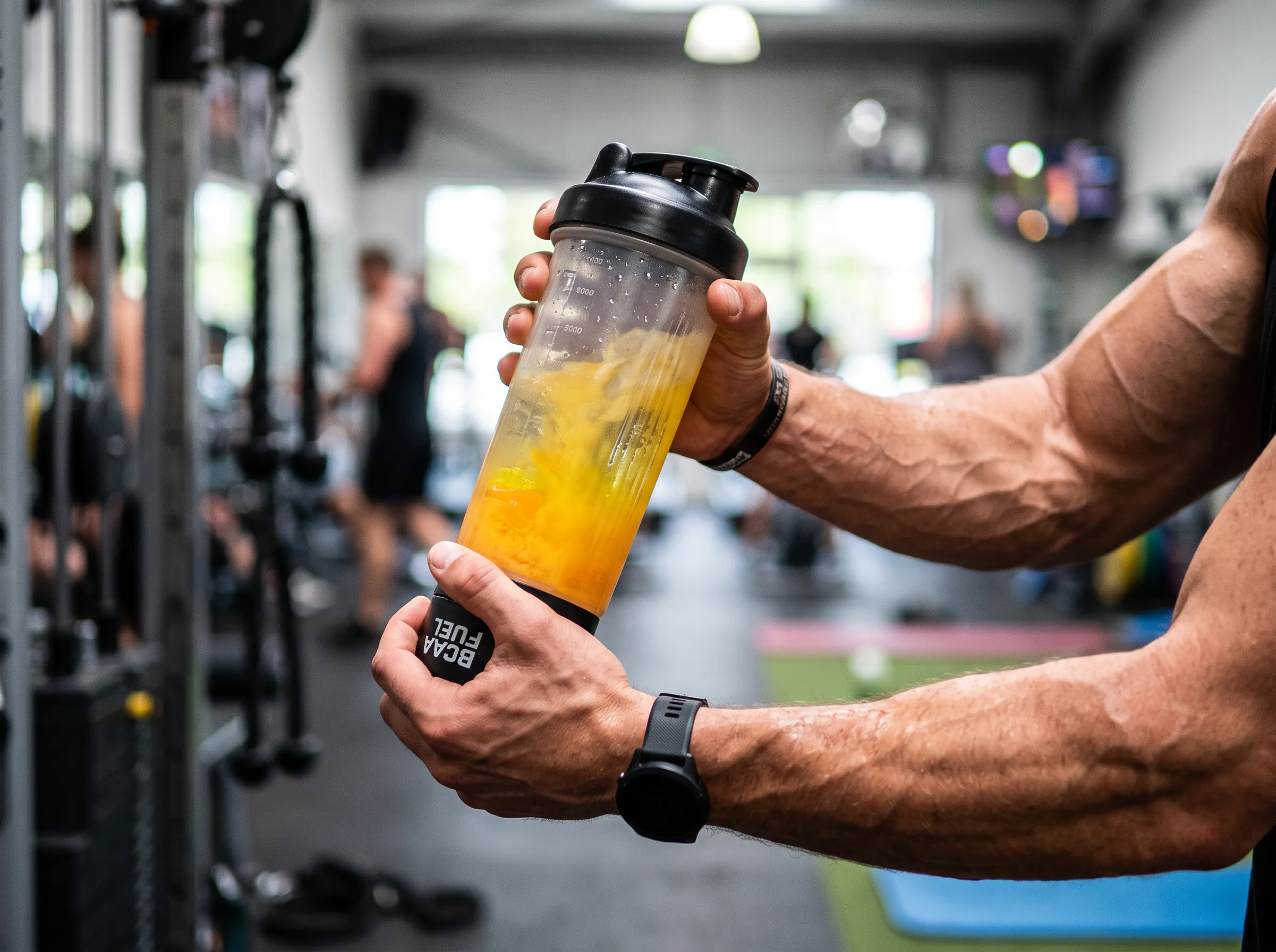 A fitness enthusiast drinking a supplement while wondering what does BCAA do for muscle recovery